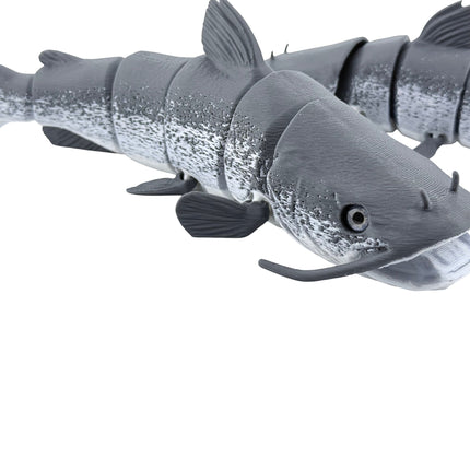 Tidal 3D Printed articulated grey catfish toy with detailed scales, whiskers, and flexible segments for movement.