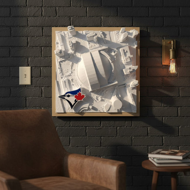 Tidal 3D Printed 12.9 x 12.9 inch framed white topographical Rogers Centre wall art with Toronto Blue Jays logo on a brick wall.